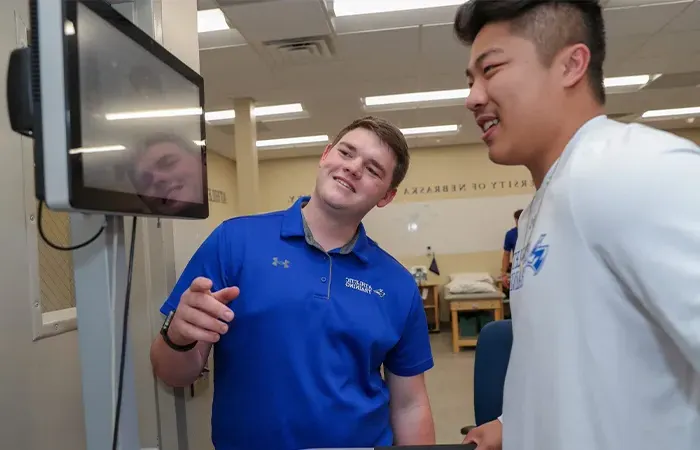 an athletic training student works with a patient